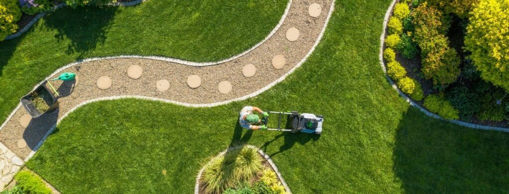 A man pushing a lawnmower.