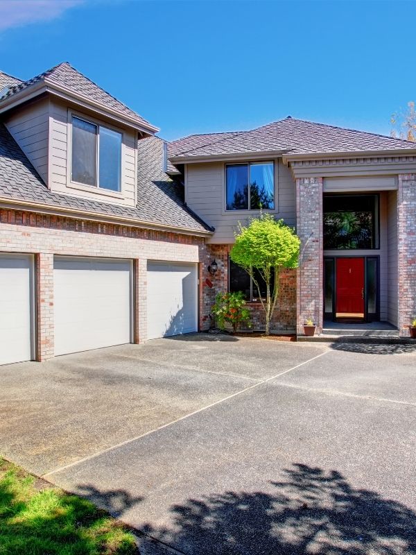A gorgeous residential home with a brand new concrete driveway.