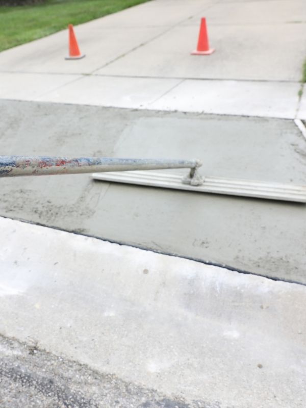 A technician is installing a concrete driveway. 