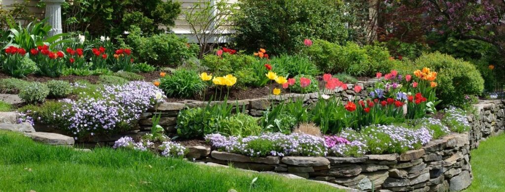 Flowers next to an immaculate lawn.